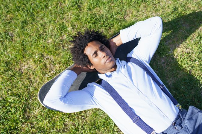 Content man lying back on his skateboard