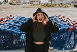 Woman screaming in parking lot with shopping carts