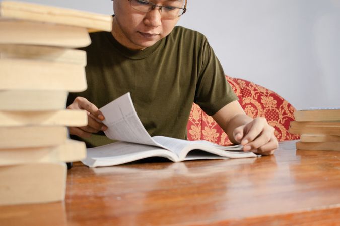Asian young student study, reading and writing sit on sofa at living room