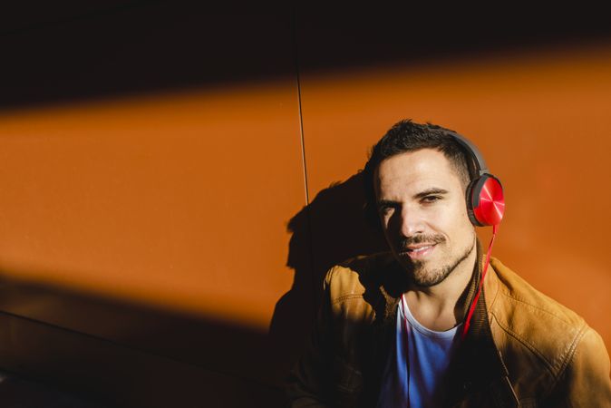Man using tablet and headphones in modern building