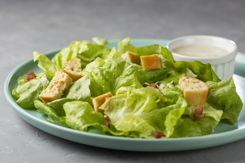 Caesar salad with croutons and bacon.