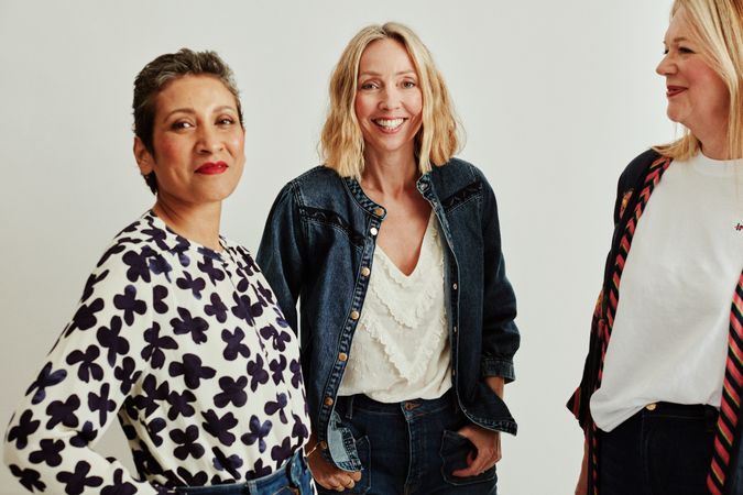 Three older women standing together in photo studio
