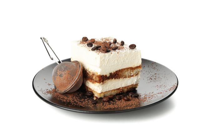 Plate with tiramisu isolated on light background. Tasty dessert