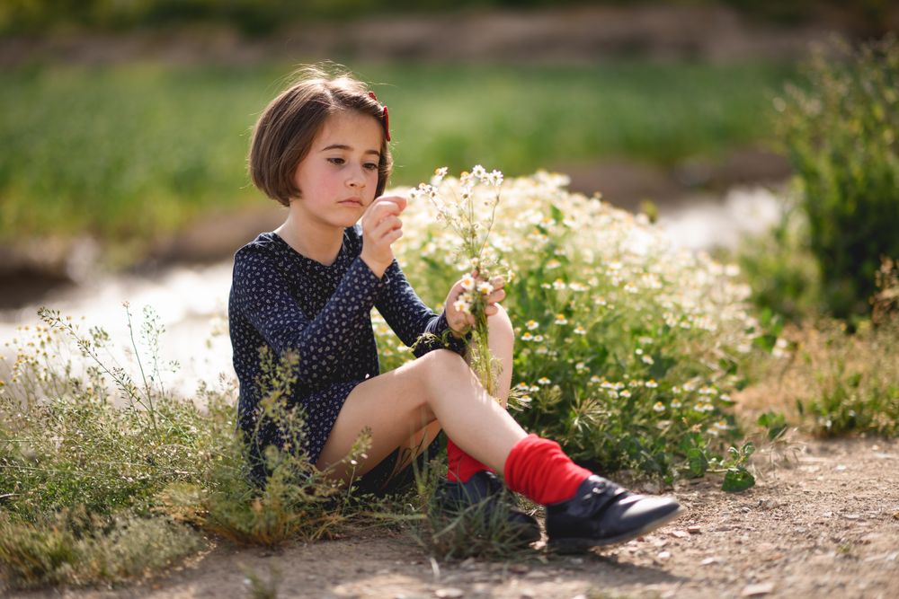 Girl picking flowers in a beautiful park