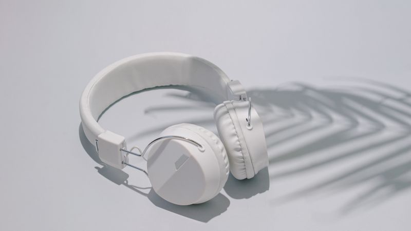 Trendy headphones with palm tree shadow