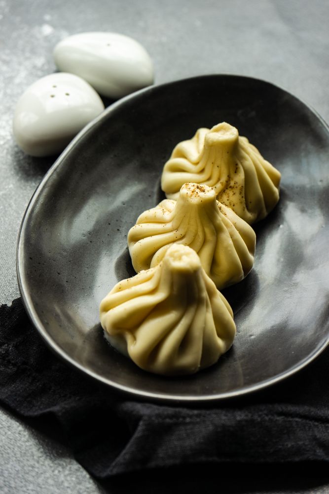 Plate of three Georgian khinkali dumplings