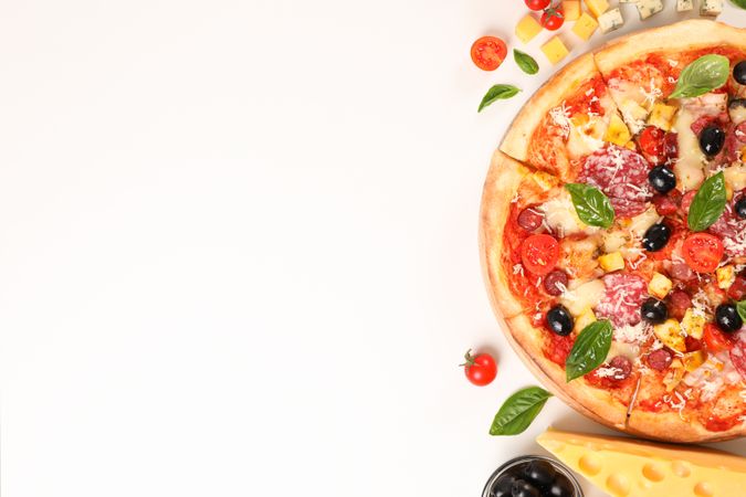 Flat lay. Pizza and ingredients: vegetables, cheese on plain background, copy space