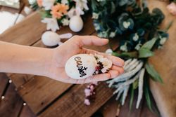 young woman holding an easter egg painted by children with flowers