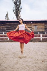Woman in colorful skirt dancing at rural paddock