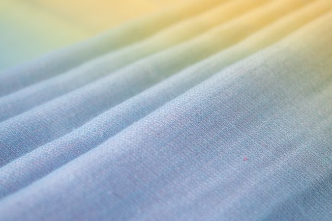Gradient colorful folded fabric background texture. blue yellow and green.