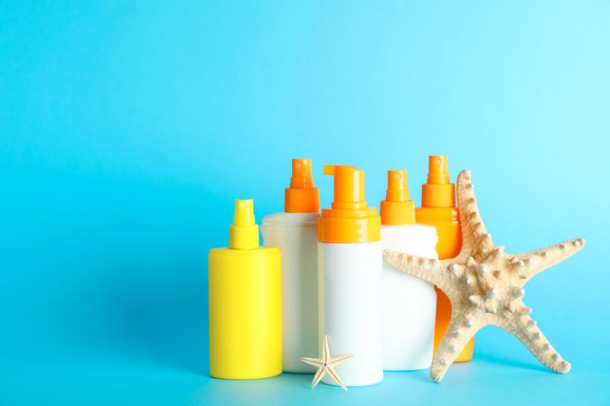 Summer vacation accessories on color background, space for text. Safe tan