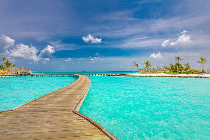 Pathway over the water leading to beach at a holiday resort, landscape