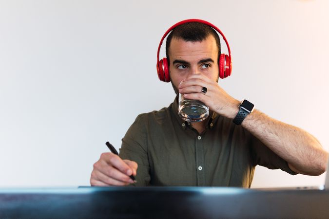 Man in headphones drinking water