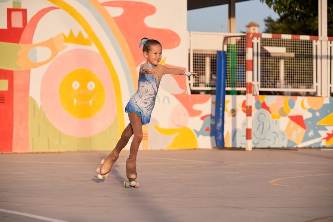 Girl riding roller skates on playground