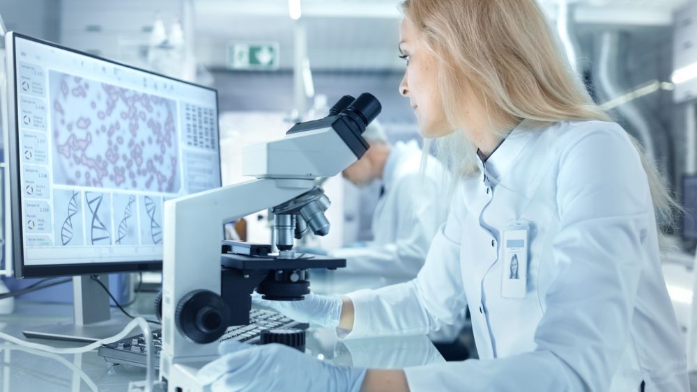 Female Research Scientist Using Electronic Microscope.