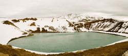 Lake between hills in snow