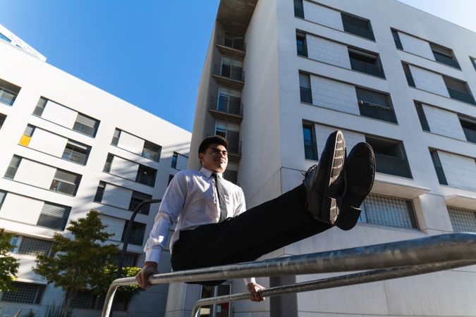 Businessman doing parkour in city district