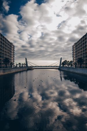 Watercanal between building and cloudy sky