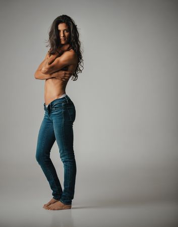Barefoot woman in jeans and bare chest