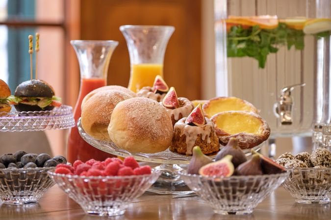 Pastry and fruits in glassware in boardroom