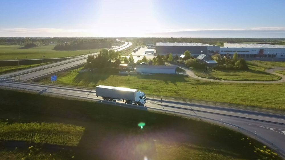 Aerial View of Semi Truck with Cargo Trailer Passing Highway Overpass