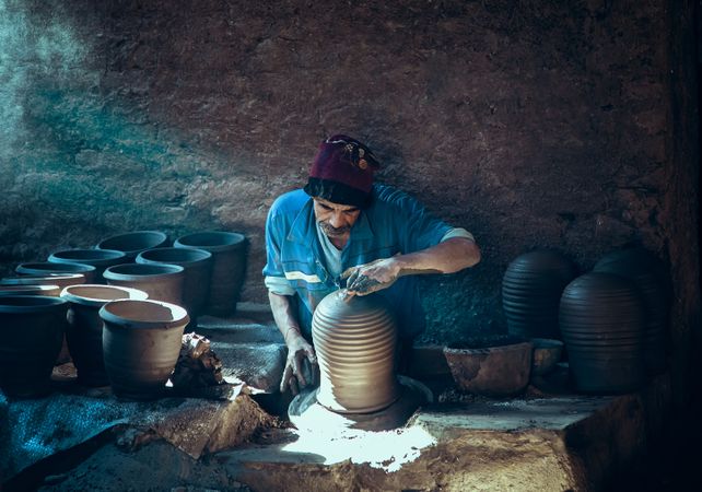 Man making pottery indoor