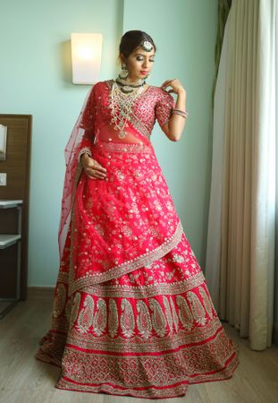 Indian bride wearing red sari indoor