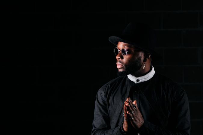 Stylish Black man in dark room
