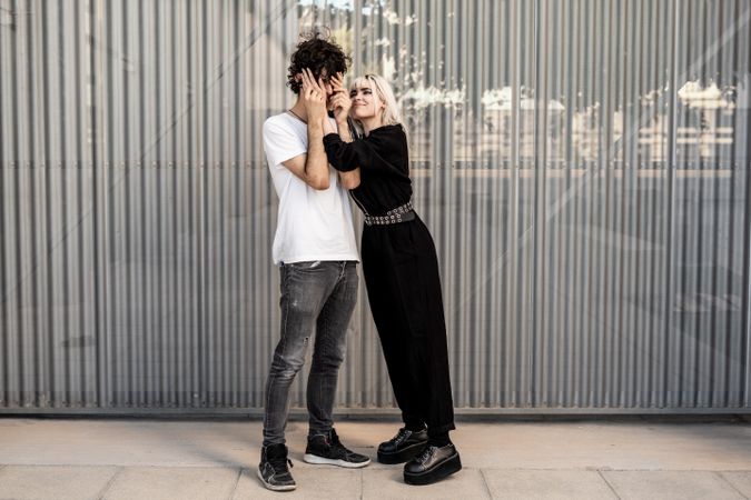 Couple near stripped modern building