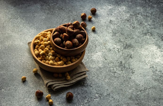 Whole & shelled hazelnuts in bowls with copy space