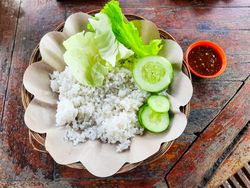 The traditional Indonesian food dish is called Ayam Penyet or fried chicken with rice and vegetables without chicken and tempeh