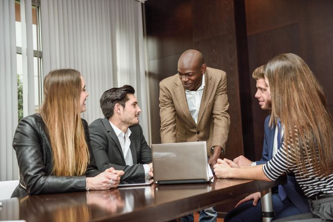 Black businessman leading his colleagues in a brain storming meeting at work