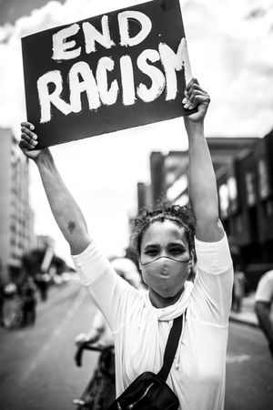 MONTREAL, QUEBEC, CANADA – June 7 2020- Woman with an “End Racism” sign