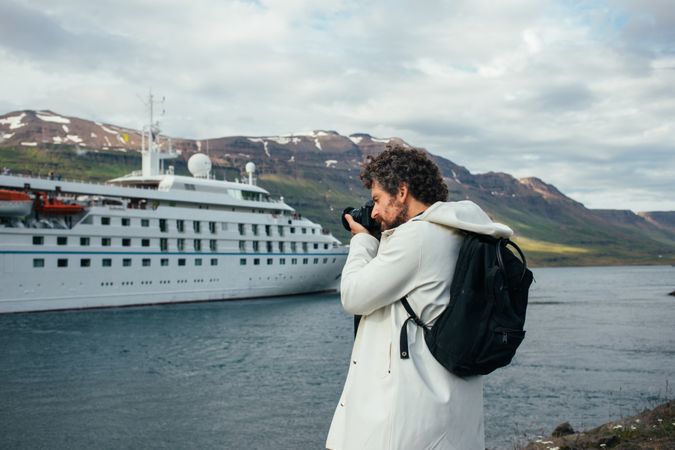 Man takes photo of cruise ship in port