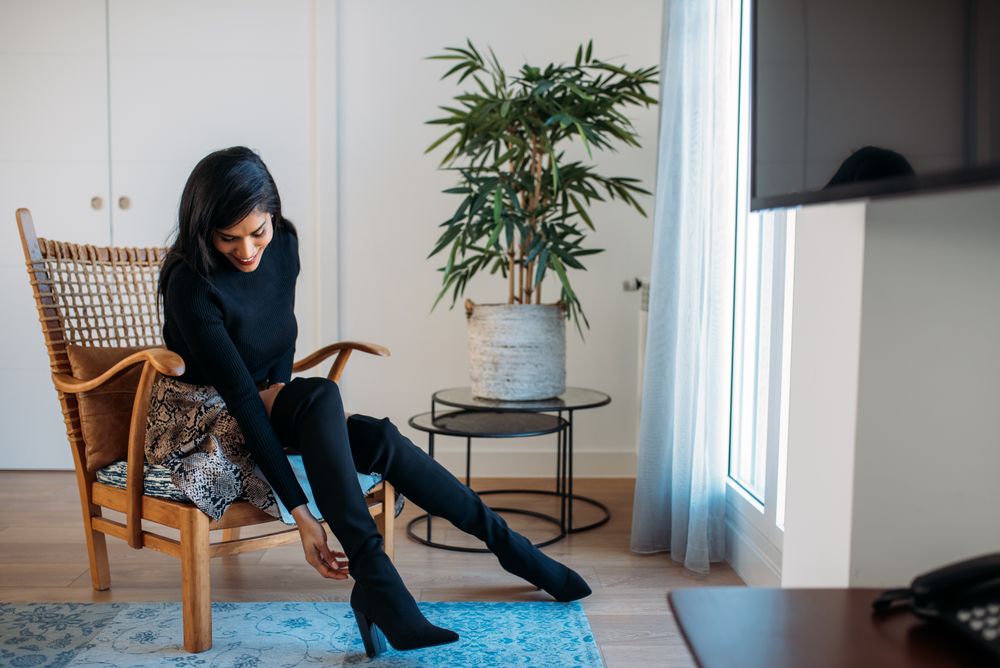 Stylist beautiful young Black woman sitting in a chair