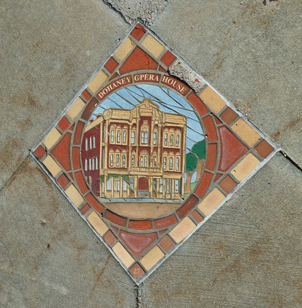 A sidewalk tile depicting the local Dohaney Opera House in Council Bluffs, Iowa