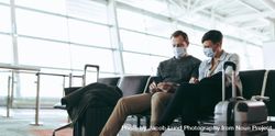 Tourists in face masks in airport wait for flight delayed or cancelled due to covid-19 lockdown 4mOAX0