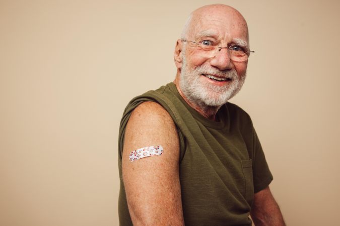 Portrait of older man smiling after getting vaccine