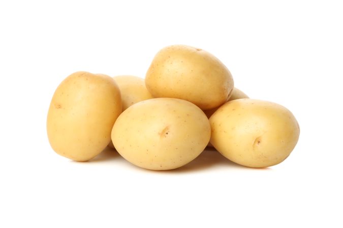 Side view of pile of potatoes in blank room