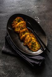 Traditional Ukrainian dish deruny, potato patties on serving plate