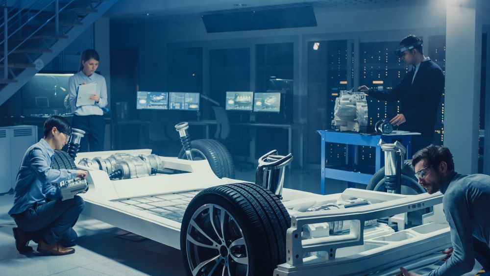 Automotive Design Engineers Work and Do Tests on Electric Car Chassis Prototype.