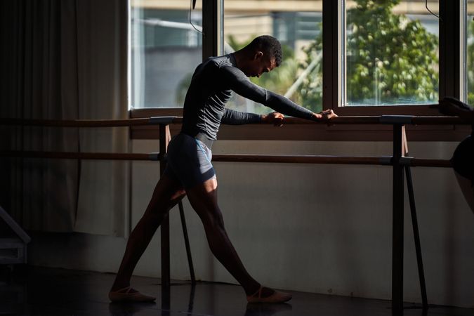 Male dancer in a warm-up and dancing in a ballet class