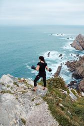 Anonymous female boxer on cliff