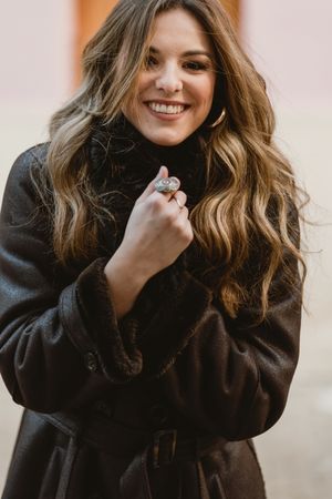 Stylish woman standing near brown door
