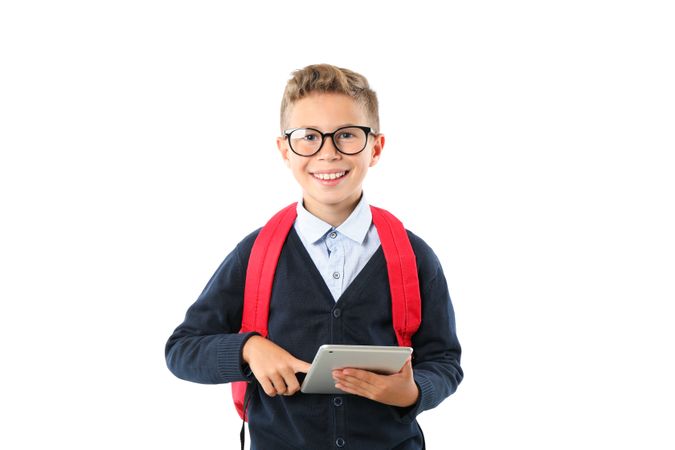 Boy with glasses and tablet isolated on blank background