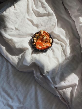 Top view of bowl of orange slices in morning light