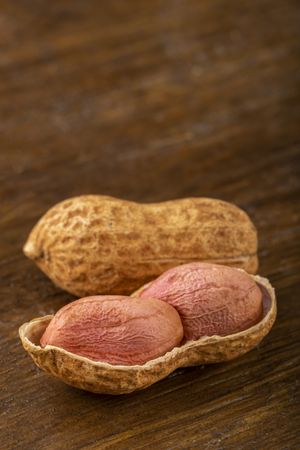 Dry peanut on the wooden background.