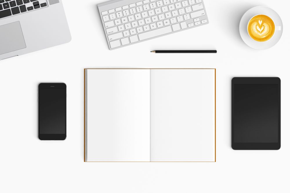 Modern workspace with coffee cup, smartphone, paper, notebook and tablet copy space