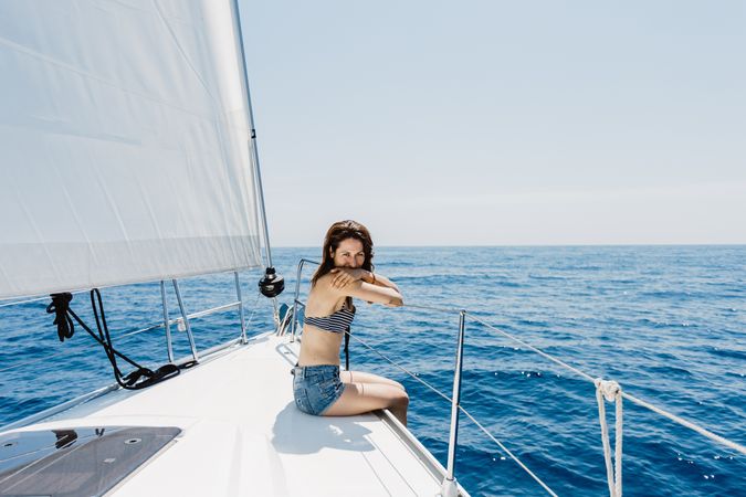 Woman in swimsuit sitting on boat