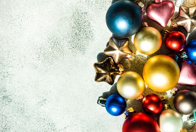 Flatlay of colorful Christmas baubles on table with copy space